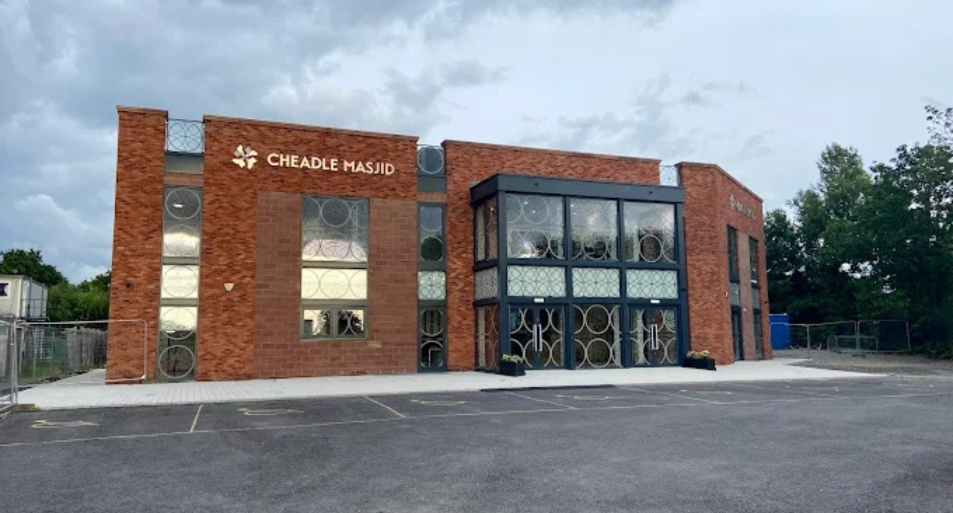 A modern building with a parking lot, labeled 'Cheadle Masjid